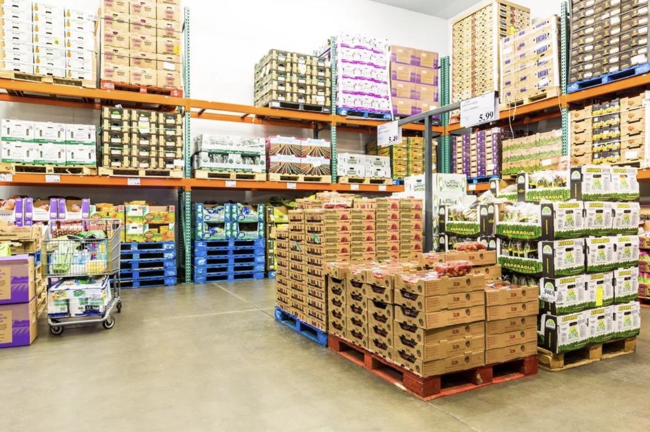 Coast Master Imports produce warehouse with pallets of fresh fruit and vegetables on racked shelving